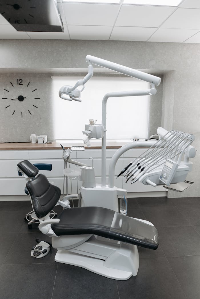 Clean and modern dental office interior with advanced equipment and dental chair.
